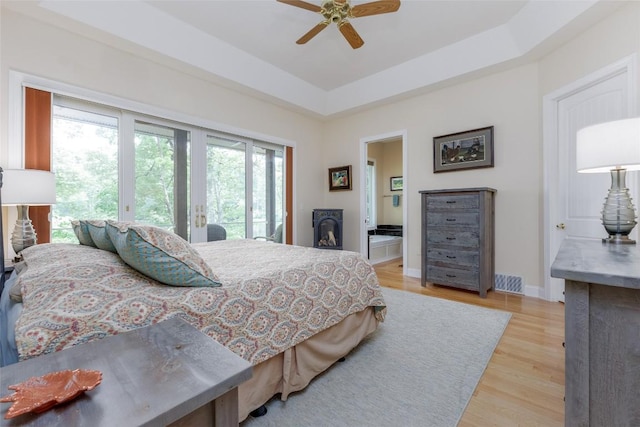 135 Whisper Lake Dr, Sapphire, NC 28774 - bedroom featuring access to outside, light wood-style flooring, a tray ceiling, and a ceiling fan