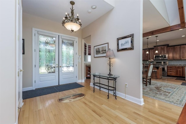 135 Whisper Lake Dr, Sapphire, NC 28774 - foyer with french doors, light wood finished floors, and a chandelier