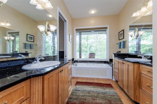 135 Whisper Lake Dr, Sapphire, NC 28774 - full bathroom featuring two vanities, wood finished floors, and a garden tub
