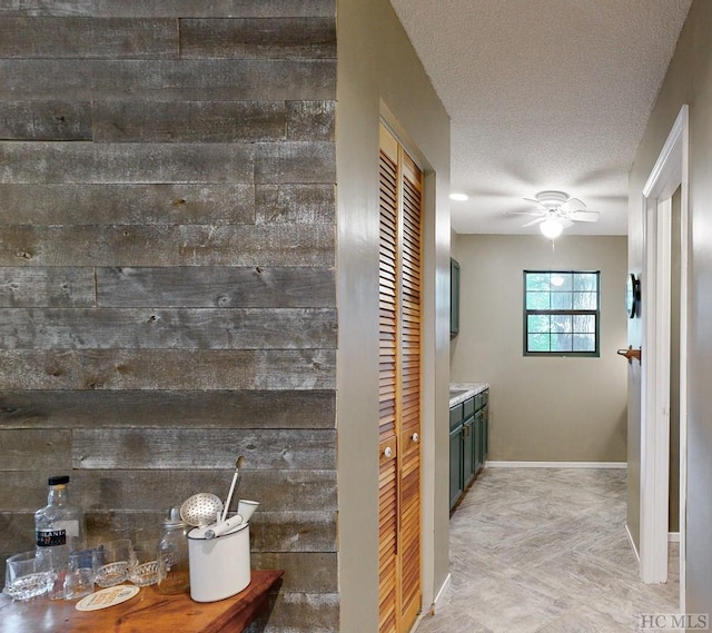 bathroom featuring ceiling fan, vanity, and a textured ceiling