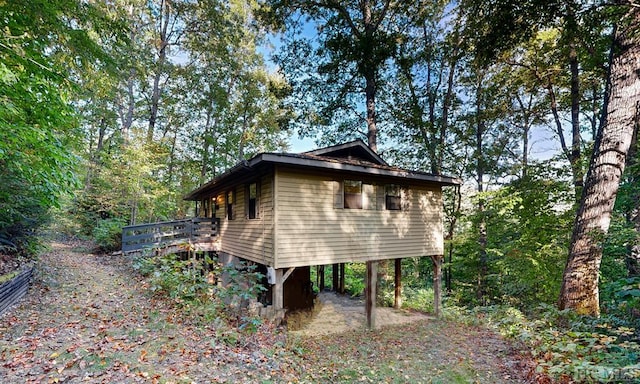 view of side of property featuring a wooden deck