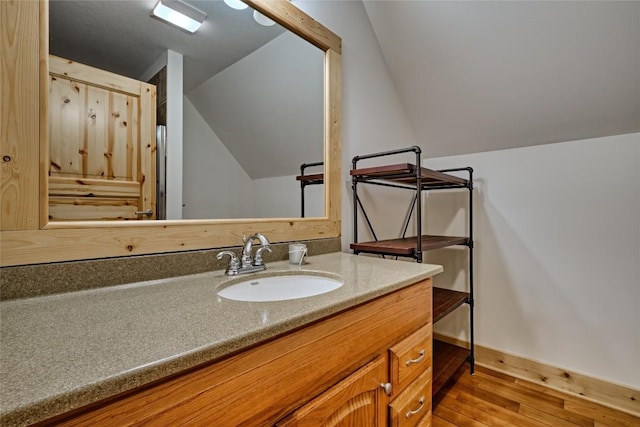 49 Lakeside Fls, Cullowhee, NC 28723 - bathroom featuring vaulted ceiling, baseboards, wood finished floors, and vanity