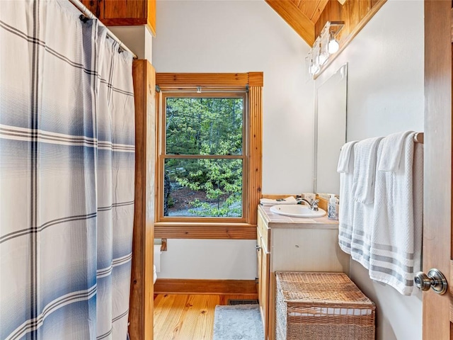399 Toxaway Ct, Lake Toxaway, NC 28747 - full bathroom featuring wood finished floors, lofted ceiling, vanity, baseboards, and a shower with shower curtain
