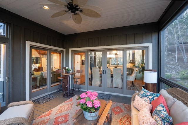 sunroom / solarium with a ceiling fan and french doors