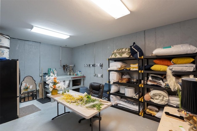 basement featuring freestanding refrigerator