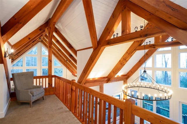 sitting room with lofted ceiling with beams, carpet floors, and a chandelier