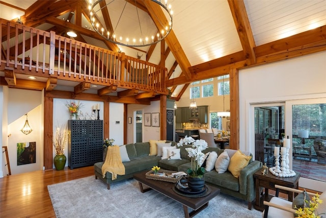 living area featuring a chandelier, beam ceiling, high vaulted ceiling, and wood finished floors