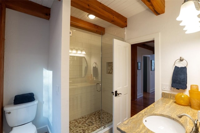 full bath featuring vanity, a shower stall, toilet, and beam ceiling