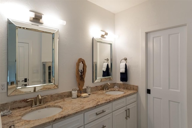 bathroom featuring a sink and double vanity