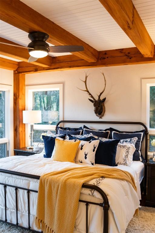 bedroom featuring beam ceiling and wood ceiling