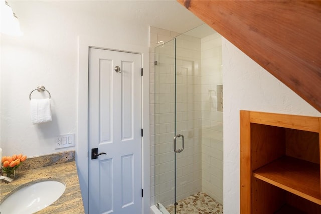 full bathroom with a shower stall and vanity