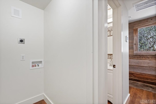 laundry area with hardwood / wood-style flooring, hookup for an electric dryer, and hookup for a washing machine