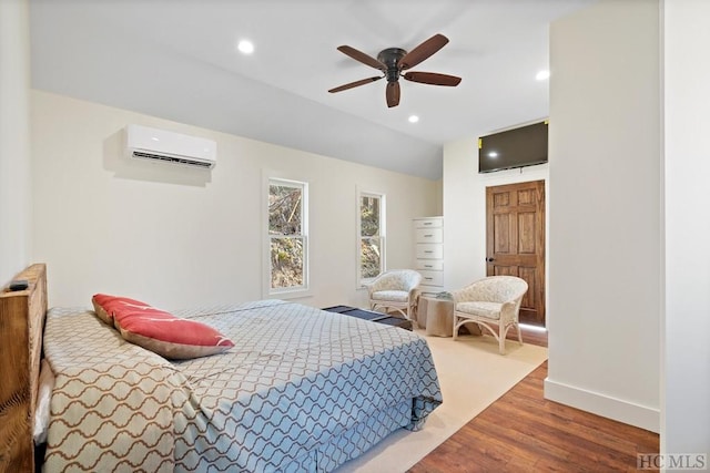 bedroom with an AC wall unit, hardwood / wood-style flooring, vaulted ceiling, and ceiling fan