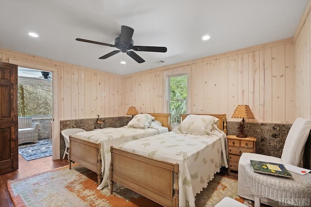 bedroom with ceiling fan, access to exterior, and wood-type flooring