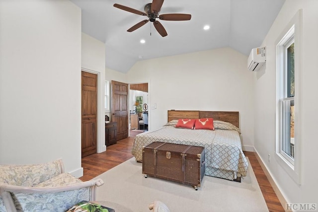 bedroom with an AC wall unit, vaulted ceiling, hardwood / wood-style floors, and ceiling fan