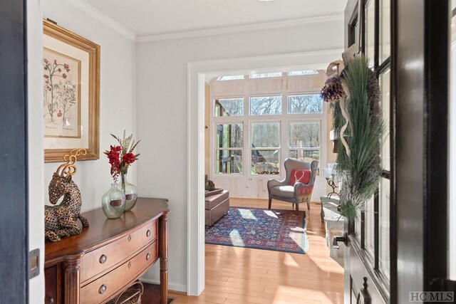 entryway featuring ornamental molding and light hardwood / wood-style floors