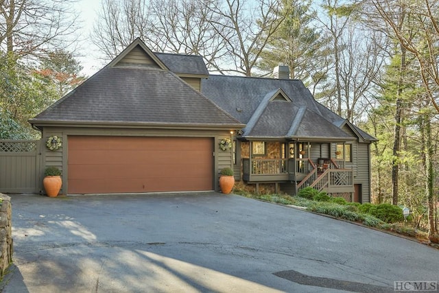 view of front of home featuring covered porch and a garage