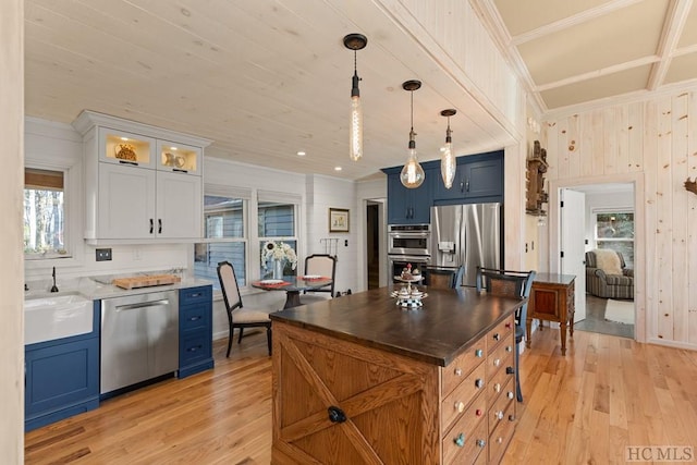 kitchen featuring white cabinets, stainless steel appliances, sink, and light wood-type flooring