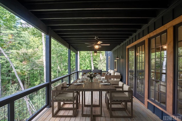 sunroom / solarium featuring ceiling fan