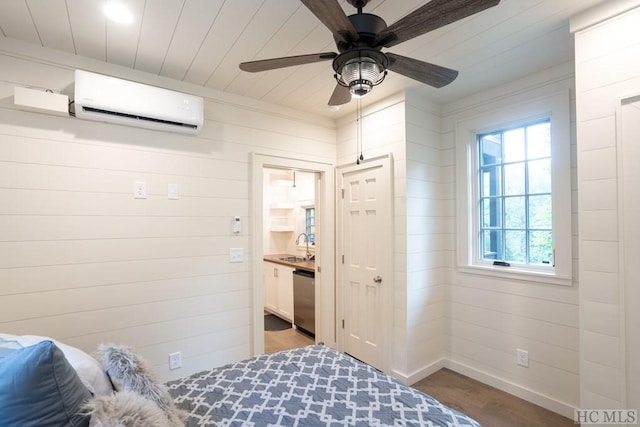 bedroom featuring an AC wall unit, sink, ceiling fan, dark wood-type flooring, and ensuite bath