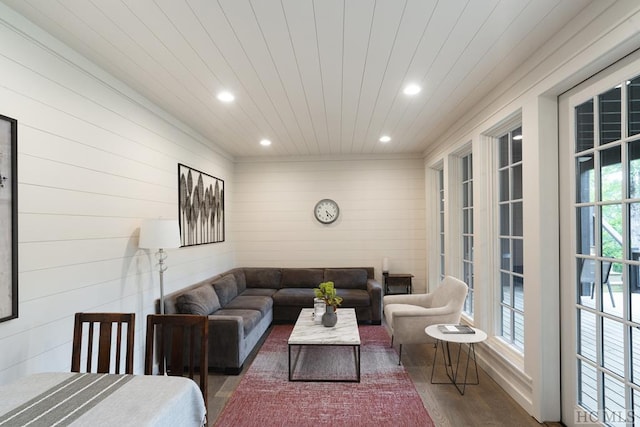 living room featuring wooden walls and dark hardwood / wood-style floors