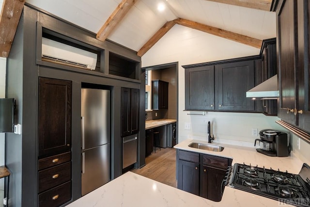 kitchen with sink, light hardwood / wood-style flooring, vaulted ceiling with beams, ventilation hood, and light stone countertops