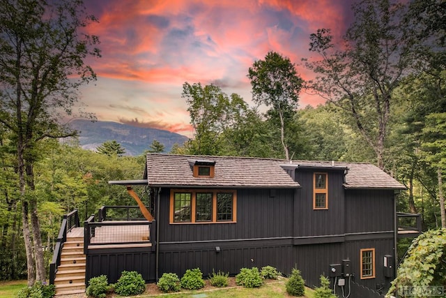 property exterior at dusk with a mountain view