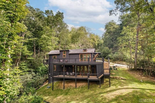 back of house featuring a yard and a deck