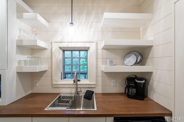 kitchen with butcher block countertops, sink, and dishwasher