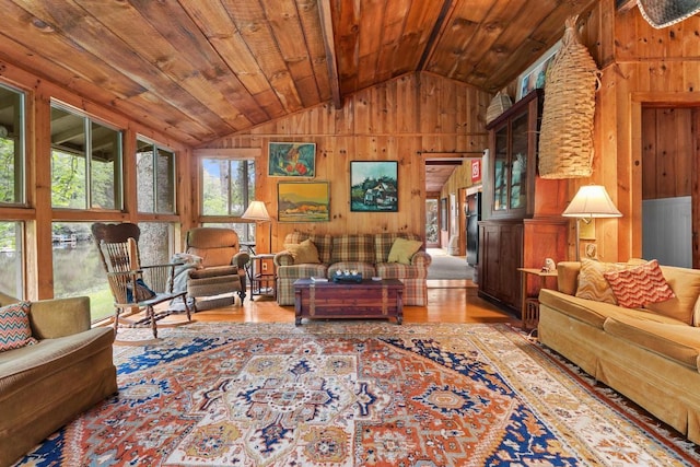 living area featuring wooden walls, lofted ceiling, wood finished floors, and wood ceiling