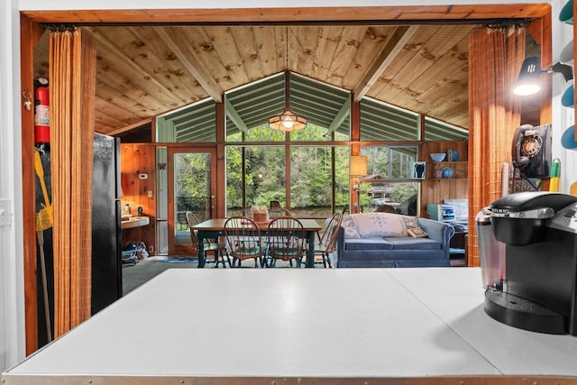 dining space featuring vaulted ceiling and wooden ceiling