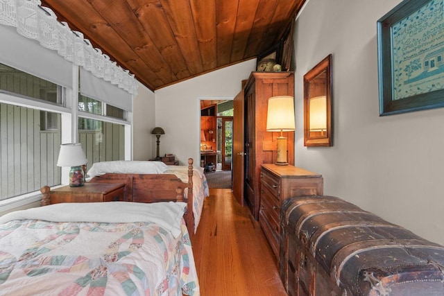 bedroom featuring wood finished floors, lofted ceiling, and wooden ceiling
