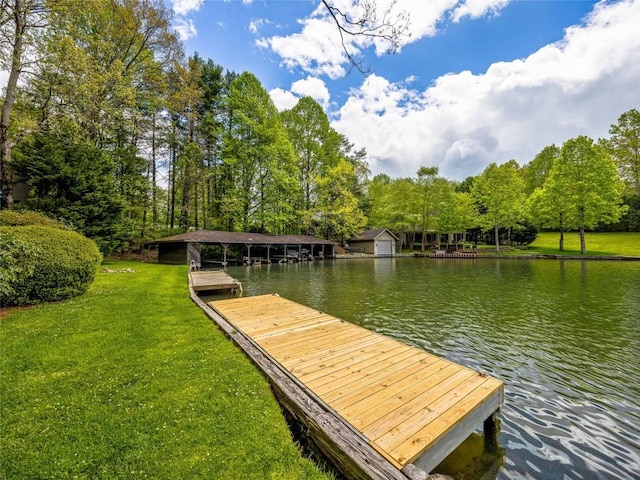 dock area with a water view and a yard