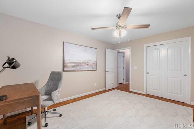 home office featuring ceiling fan and light hardwood / wood-style flooring