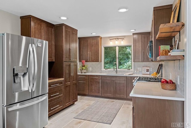 kitchen featuring sink, backsplash, and stainless steel appliances