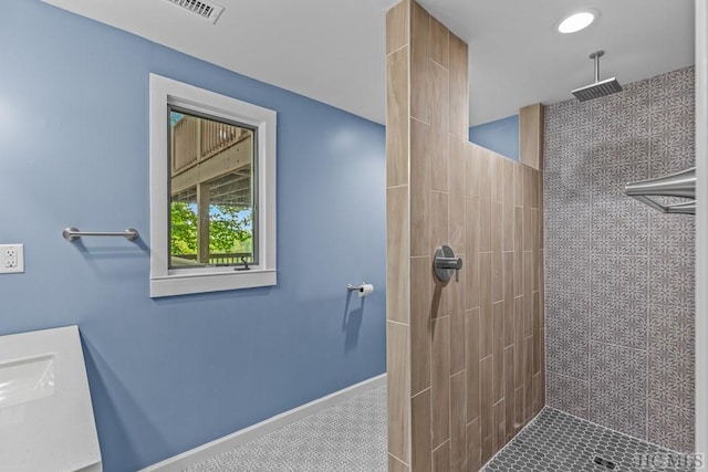 bathroom featuring tiled shower and tile patterned floors