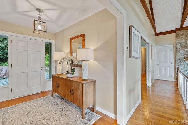 entrance foyer with beam ceiling and light wood-type flooring