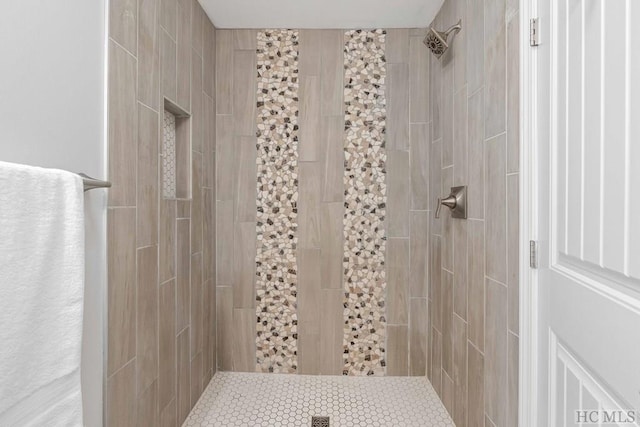 bathroom with a tile shower