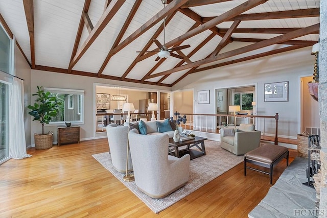 living room featuring hardwood / wood-style flooring, ceiling fan, beam ceiling, and high vaulted ceiling