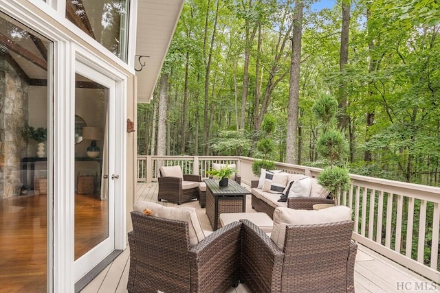 wooden deck with an outdoor living space