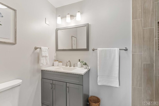 bathroom featuring vanity and toilet