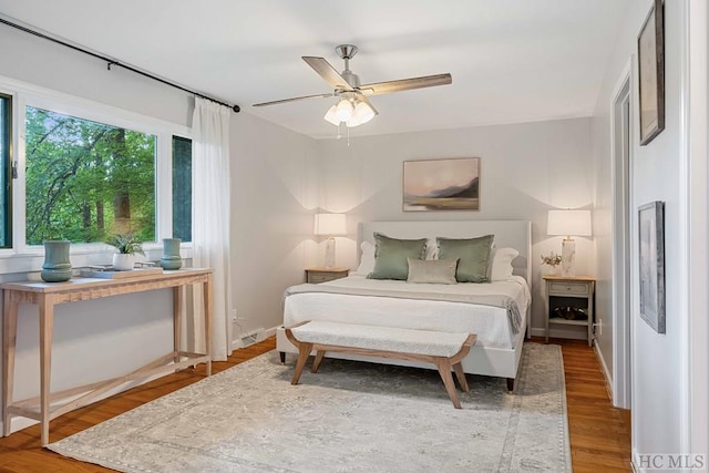 bedroom with hardwood / wood-style floors and ceiling fan