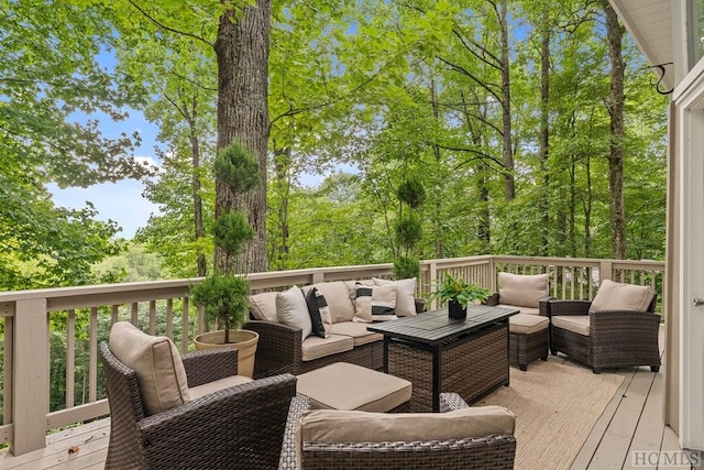 wooden terrace with an outdoor living space