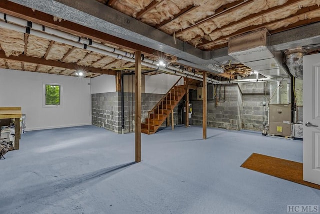 basement featuring water heater and heating unit