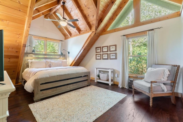 bedroom featuring dark wood-type flooring, lofted ceiling with beams, and multiple windows