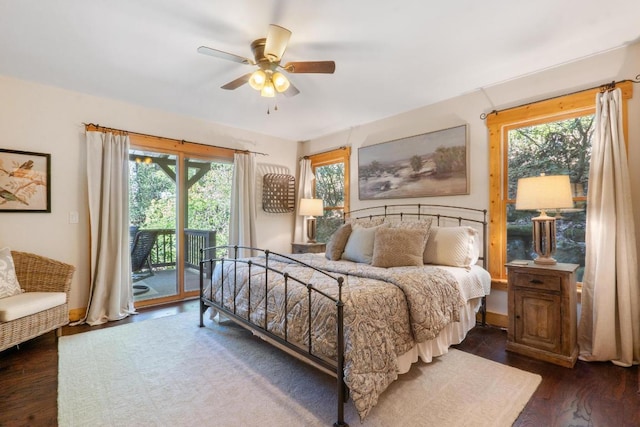 bedroom featuring access to outside, baseboards, dark wood-style floors, and multiple windows