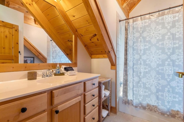bathroom featuring tile patterned flooring, vanity, shower / bath combination with curtain, wooden ceiling, and vaulted ceiling with beams