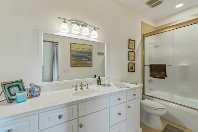 full bathroom with toilet, enclosed tub / shower combo, and vanity