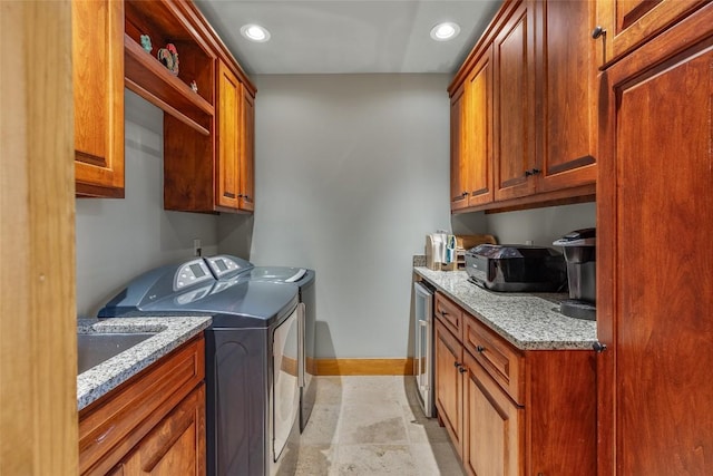 washroom with cabinets and washing machine and dryer