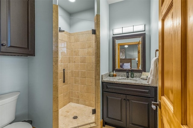 bathroom featuring an enclosed shower, vanity, and toilet